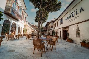 a patio with tables and chairs in a building at Konak Avula Boutique Hotel in Hatay