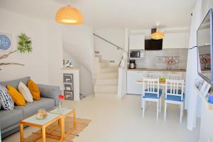 a living room with a couch and a table and a kitchen at Apartments Stefani in Fažana