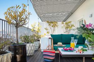 a patio with a table and some plants at BLESS Madrid - The Leading Hotels of the World in Madrid