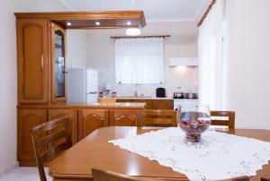 a kitchen with a wooden table with a wine glass on it at Angelica's Apartment in Kissamos
