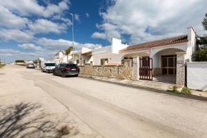 a street with cars parked in front of houses at Villa Rosa di Mare by BararHouse in Torre Lapillo