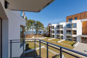 an apartment balcony with a view of a courtyard at VacationClub - Let’s Sea Baltic Park B44 in Gąski