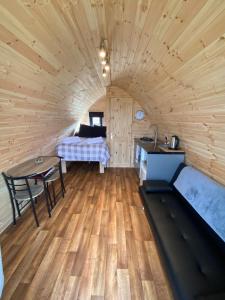 a room with a bed and a table in a cabin at Arisaig Pods in Arisaig