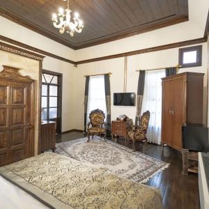 a bedroom with a bed and a table and chairs at Konak Avula Boutique Hotel in Hatay
