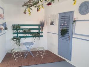 a patio with a table and chairs and a blue door at InFresh holiday house in Šibenik