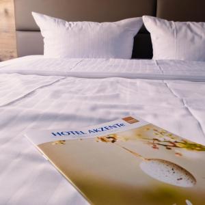 a book sitting on top of a bed at Akzent Hotel Saltenhof in Hörstel