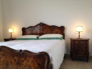a bedroom with a large bed with two night stands at Domus Petrae - Ripatransone in Ripatransone