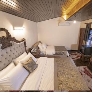 a hotel room with two beds in a room at Konak Avula Boutique Hotel in Hatay +17 photos