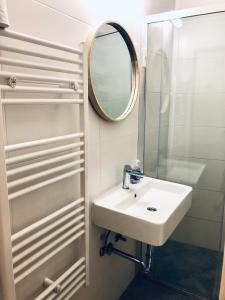 a bathroom with a sink and a mirror at OLD COURT KOPER in Koper