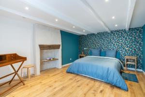 1 dormitorio con paredes azules, 1 cama y piano en Ker Pesketaer, en Plouhinec