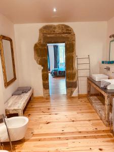 a bathroom with two sinks and two toilets at Chambres d'Hôtes Domaine Saint-Joly in Lasbordes