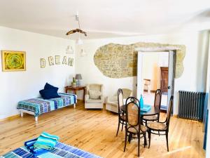 a room with a table and chairs and a bed at Chambres d'Hôtes Domaine Saint-Joly in Lasbordes