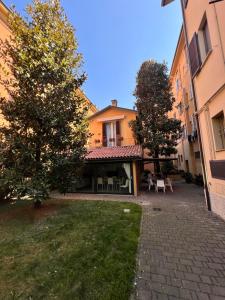a house with a patio and trees in a yard at La Magnolia B&B in Bologna