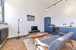 a living room with a couch and a table at No 2 at Simpson Street Apartments Sunderland in Sunderland