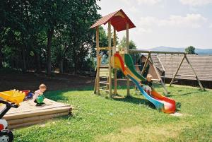 two children playing on a playground with a slide at Frühstückspension Binder in Harbach