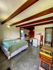 a bedroom with a bed and a table in a room at Água Doce in Sao Jorge