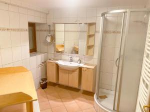 a bathroom with a sink and a shower at Landgasthof Adler Pelzmühle in Biederbach Baden-Württemberg