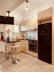 a kitchen with a black refrigerator and a counter at Diamond Apartment in Athens