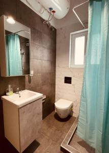 a bathroom with a sink and a toilet at Diamond Apartment in Athens