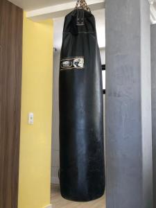 a black punching bag hanging from a wall at APARTAMENTO EM NATAL II in Natal