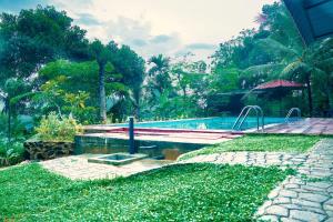 a swimming pool in front of a resort at Discovery resort in Ratnapura