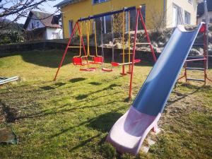 a playground with a slide in a yard at Ferienwohnung Dinkelbergblick Öflingen in Wehr