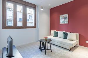 a living room with a couch and a table at Modern Apartment close to City Centre in Valencia