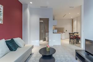 Modern Apartment close to City Centre في فالنسيا: غرفة معيشة مع أريكة بيضاء وطاولة