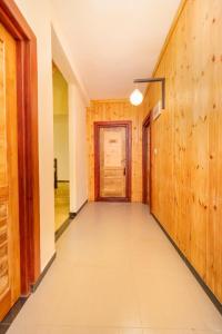 a hallway with wooden walls and a door at 3 Arch Resort Ella in Ella