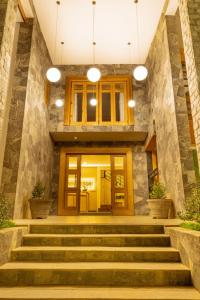 a lobby with stairs leading to a building at 3 Arch Resort Ella in Ella