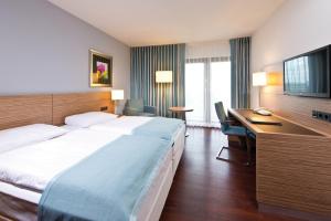 Postel nebo postele na pokoji v ubytování Maritim Hotel Darmstadt