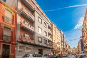 a city street with cars parked in front of buildings at Modern, Stylish Apartment in Valencia