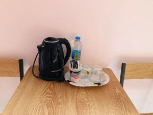 a table with a tea kettle and affeepot on it at 243Hotel in Ta Phraya