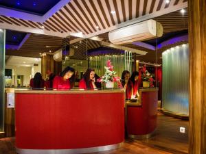 a group of women sitting at a bar in a restaurant at Madu Inn in Jakarta