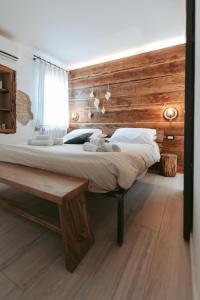 a bedroom with a large bed with a wooden wall at Laguna Suite B&B in Chioggia
