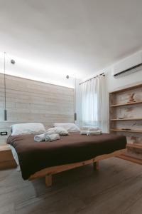 Schlafzimmer mit einem großen Bett mit einem Kopfteil aus Holz in der Unterkunft Laguna Suite B&B in Chioggia