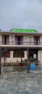 a building with a sign on the top of it at Star Sianna Village Rooms to let in Siána