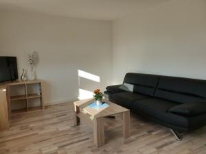 a living room with a couch and a coffee table at Spreewald Alte Mühle Bischdorf-Lübbenau in Bischdorf +9 photos
