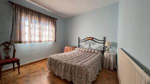 1 dormitorio con cama y ventana en LA PARRA - Casa Rural en el Valle del Jerte en Navaconcejo