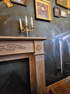 a fireplace with candles on top of it at L'Entre 2 Cols in Saint-Martin-sur-le-Chambre