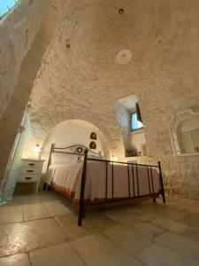 Ένα ή περισσότερα κρεβάτια σε δωμάτιο στο Trulli Occhi Di Pietra