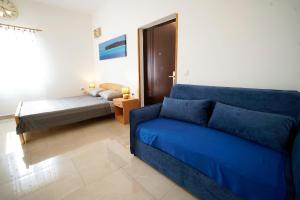 a living room with a couch and a bed at Apartments Roberta in Kožino +42 photos
