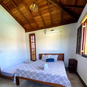 a bedroom with a bed with a teddy bear on it at Bahia Soul - Bangalô Lua - Grupo Barril Hospedagens in Marau +64 photos