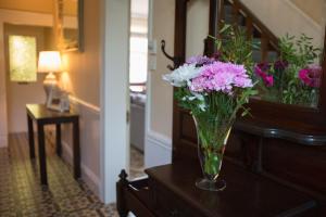 a vase of flowers on a table in a room at Riverdale House B&B in Athlone