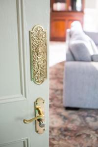 a door with a gold door knob and a couch at Riverdale House B&B in Athlone