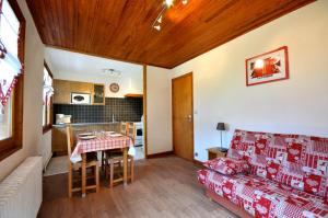 a living room with a couch and a table at Piste B in Morzine +18 photos