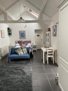 a living room with a blue couch and a table at Jollys of Goodrich in Goodrich