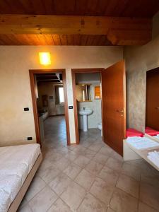 a bedroom with a bed and a bathroom at Il Poggio Agrisport in Poirino