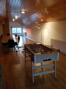 a room with a large foosball table and a dining room at Vila Sanne Brașov , Hălchiu in Heldsdorf