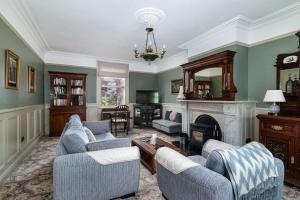 a living room with two couches and a fireplace at Riverdale House B&B in Athlone